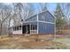 View of the house with a long porch and expansive backyard surrounded by trees at 12507 N Roxboro St, Rougemont, NC 27572