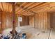 Partially finished basement showcasing exposed wooden beams and natural lighting at 12507 N Roxboro St, Rougemont, NC 27572