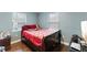 Cozy bedroom with wood floors, two windows, and a comfortable bed at 12507 N Roxboro St, Rougemont, NC 27572