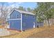 Two-story home with blue siding, showcasing its curb appeal and inviting entrance at 12507 N Roxboro St, Rougemont, NC 27572