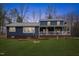 Charming blue two-story home with covered porch and well-maintained front yard at 12507 N Roxboro St, Rougemont, NC 27572