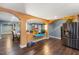Open floor plan with tile floors, stainless steel refrigerator, and access to dining area at 12507 N Roxboro St, Rougemont, NC 27572