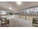 Expansive covered porch with neutral tile, white railings, and comfortable wicker seating at 12507 N Roxboro St, Rougemont, NC 27572