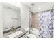 Bright bathroom with a white vanity, tub with shower, and decorative shower curtain at 158 Futrell Ridge Ct, Chapel Hill, NC 27517