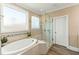 This bathroom features a tub, a glass shower, and a large window that provides an abundance of natural light at 158 Futrell Ridge Ct, Chapel Hill, NC 27517