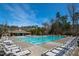Relaxing community pool with plenty of lounge chairs on a sunny day at 158 Futrell Ridge Ct, Chapel Hill, NC 27517