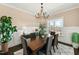 Chandelier illuminates a spacious dining room with a dark wood table and large windows at 158 Futrell Ridge Ct, Chapel Hill, NC 27517