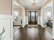 Elegant foyer with dark wood floors, chandelier, and paneled walls creates a grand entrance at 158 Futrell Ridge Ct, Chapel Hill, NC 27517