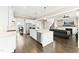 Open concept kitchen with island and bar seating, stainless steel appliances, and connection to living room at 158 Futrell Ridge Ct, Chapel Hill, NC 27517