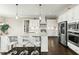 Bright kitchen with island and bar seating, white cabinets, stainless steel appliances, and wood floors at 158 Futrell Ridge Ct, Chapel Hill, NC 27517