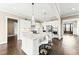 Modern white kitchen with a large island, granite countertops, and stainless steel appliances at 158 Futrell Ridge Ct, Chapel Hill, NC 27517