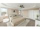 This bedroom features a tray ceiling, a ceiling fan, and lots of natural light from the windows at 158 Futrell Ridge Ct, Chapel Hill, NC 27517