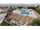 Stunning community pool and splash pad with plenty of lounge seating and pergolas for shade at 167 S Harvest Ridge Way # Homesite 223, Wilson's Mills, NC 27520