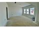 Unfinished living room with three windows providing ample natural light at 167 S Harvest Ridge Way # Homesite 223, Wilson's Mills, NC 27520