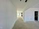 Unfinished living room featuring white walls and ceiling, with open access to the kitchen and a view of the door and windows at 167 S Harvest Ridge Way # Homesite 223, Wilson's Mills, NC 27520