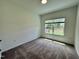 Cozy bedroom with plush carpeting and a large window overlooking the backyard at 167 S Harvest Ridge Way # Homesite 223, Wilson's Mills, NC 27520