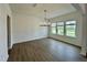 Bright dining room with hardwood floors, elegant chandelier, and large windows overlooking the front yard at 167 S Harvest Ridge Way # Homesite 223, Wilson's Mills, NC 27520