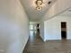 Inviting foyer with hardwood floors, white walls, and a view into the kitchen and main living area at 167 S Harvest Ridge Way # Homesite 223, Wilson's Mills, NC 27520