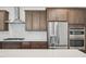 Modern kitchen with stainless steel appliances, ample cabinet space, and attractive backsplash at 167 S Harvest Ridge Way # Homesite 223, Wilson's Mills, NC 27520