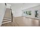 Well-lit living area with stairs, modern flooring, and outdoor access at 167 S Harvest Ridge Way # Homesite 223, Wilson's Mills, NC 27520