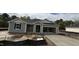 New construction home features gray siding, an attached two-car garage, and a freshly poured concrete driveway at 178 Gobbler Dr, Smithfield, NC 27577