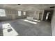 Spacious kitchen area featuring multiple windows, bare concrete floors, and an open layout at 178 Gobbler Dr, Smithfield, NC 27577