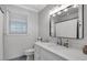 Bathroom featuring vanity with single sink, mirror, and tiled floor at 1820 Carrington Dr, Raleigh, NC 27615