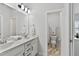 Bright bathroom featuring a double vanity, modern fixtures, and a view into the toilet and shower area at 1872 Stagecoach Trl, Wendell, NC 27591