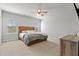 Spacious bedroom with a natural wood frame bed, a ceiling fan, and two windows at 1872 Stagecoach Trl, Wendell, NC 27591