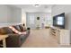 Spacious bonus room with neutral walls, plush carpeting, a comfortable sofa, and a media center at 1872 Stagecoach Trl, Wendell, NC 27591
