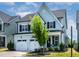 A well-maintained two-story home featuring a two-car garage, black shutters, and neat landscaping at 1872 Stagecoach Trl, Wendell, NC 27591