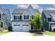 Inviting two-story home with a two-car garage, charming front porch, and well-maintained landscaping at 1872 Stagecoach Trl, Wendell, NC 27591