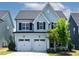 Charming two-story home featuring a two-car garage, neat landscaping, and a cozy front entrance at 1872 Stagecoach Trl, Wendell, NC 27591