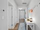 Inviting hallway with light walls, wood floors and stylish decorations leading to the front door at 1872 Stagecoach Trl, Wendell, NC 27591