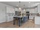 Bright kitchen showcases granite countertops, stainless appliances, and an island with bar seating at 1872 Stagecoach Trl, Wendell, NC 27591