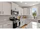 Modern kitchen featuring stainless steel appliances, granite countertops and a center island at 1872 Stagecoach Trl, Wendell, NC 27591