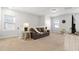 Cozy living room with a comfortable sofa, side tables, and carpeted floors at 1872 Stagecoach Trl, Wendell, NC 27591