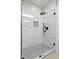 Modern shower with marble-patterned tile walls, mosaic tile flooring, and a sleek rain shower head at 1872 Stagecoach Trl, Wendell, NC 27591