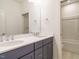 Bathroom featuring double sink vanity with modern fixtures and tiled shower at 213 Big Bradley Dr, Wendell, NC 27591