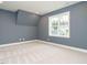 Bedroom with light carpet, a large window, and painted gray walls at 213 Big Bradley Dr, Wendell, NC 27591
