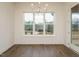 Spacious dining area features a modern chandelier and large windows with scenic view at 213 Big Bradley Dr, Wendell, NC 27591