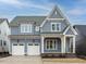 Charming two-story home with a gray exterior, white trim, and a two-car garage at 213 Big Bradley Dr, Wendell, NC 27591