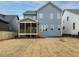 Back exterior of a gray home with screened-in porch and a flat backyard at 213 Big Bradley Dr, Wendell, NC 27591