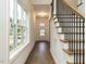 Inviting foyer with hardwood floors, a staircase, and a view of the front door at 213 Big Bradley Dr, Wendell, NC 27591