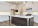 Stylish kitchen featuring a large island, white cabinets, stainless steel appliances, and pendant lighting at 213 Big Bradley Dr, Wendell, NC 27591