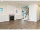 Bright open-concept living room features a cozy fireplace and staircase to the upper level at 213 Big Bradley Dr, Wendell, NC 27591