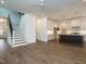 Bright open-concept living room features a kitchen island and staircase to the upper level at 213 Big Bradley Dr, Wendell, NC 27591