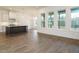 Bright open-concept living room features a kitchen island and access to the porch at 213 Big Bradley Dr, Wendell, NC 27591