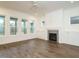 Bright open-concept living room features a cozy fireplace and access to the porch at 213 Big Bradley Dr, Wendell, NC 27591