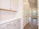 Convenient pantry space with ample storage, white cabinets, and a view into another room at 213 Big Bradley Dr, Wendell, NC 27591